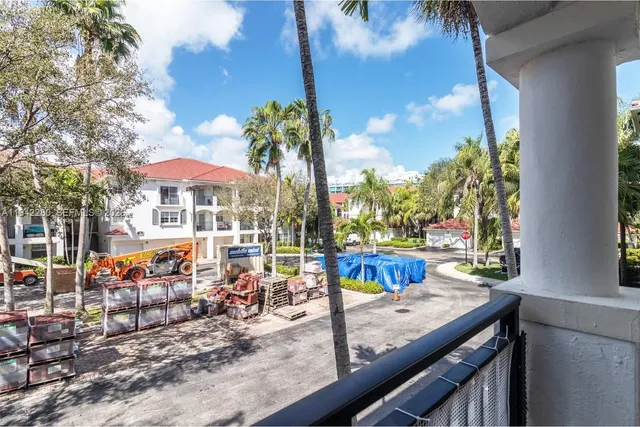 a view of a porch with chairs and potted plants