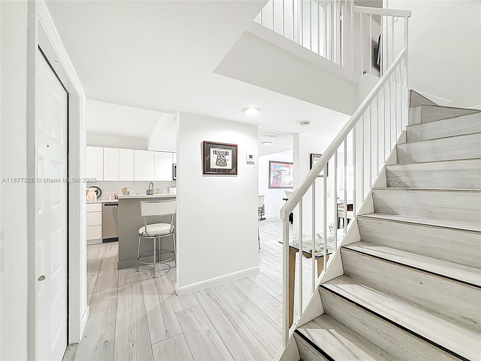 7110 Southwest 54th Street Miami, FL 33155 - Photo 11 of 40 a view of entryway and kitchen with wooden floor