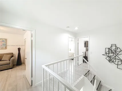 a view of a livingroom with furniture and stairs