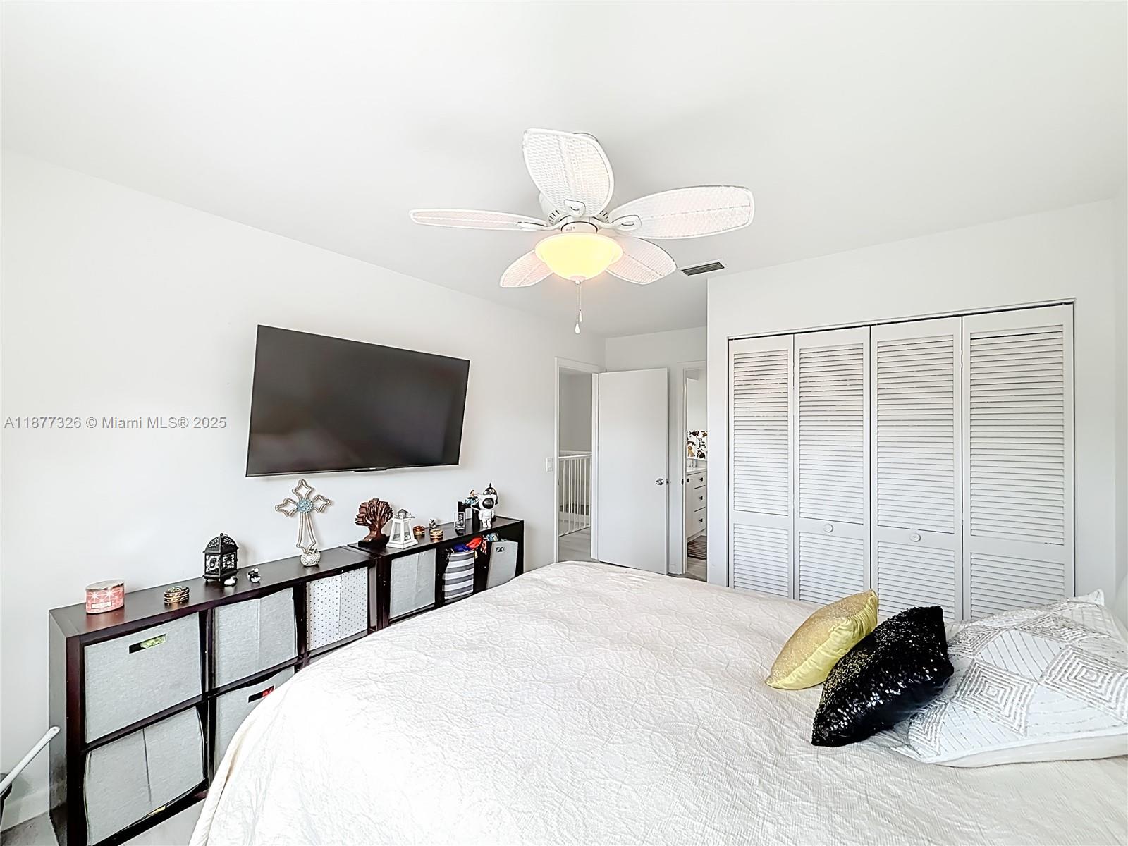 7110 Southwest 54th Street Miami, FL 33155 - Photo 18 of 40 a bedroom with a bed and a flat screen tv