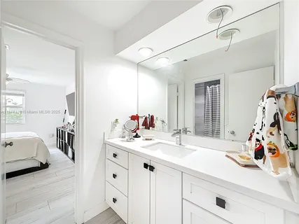 a en suite bathroom with a sink double vanity and mirror