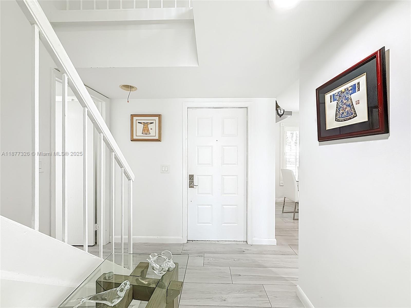 7110 Southwest 54th Street Miami, FL 33155 - Photo 2 of 40 a view of a hallway with furniture and front door