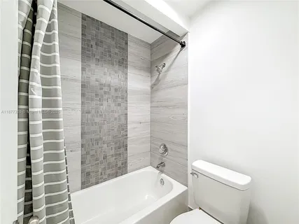 a bathroom with a toilet and shower