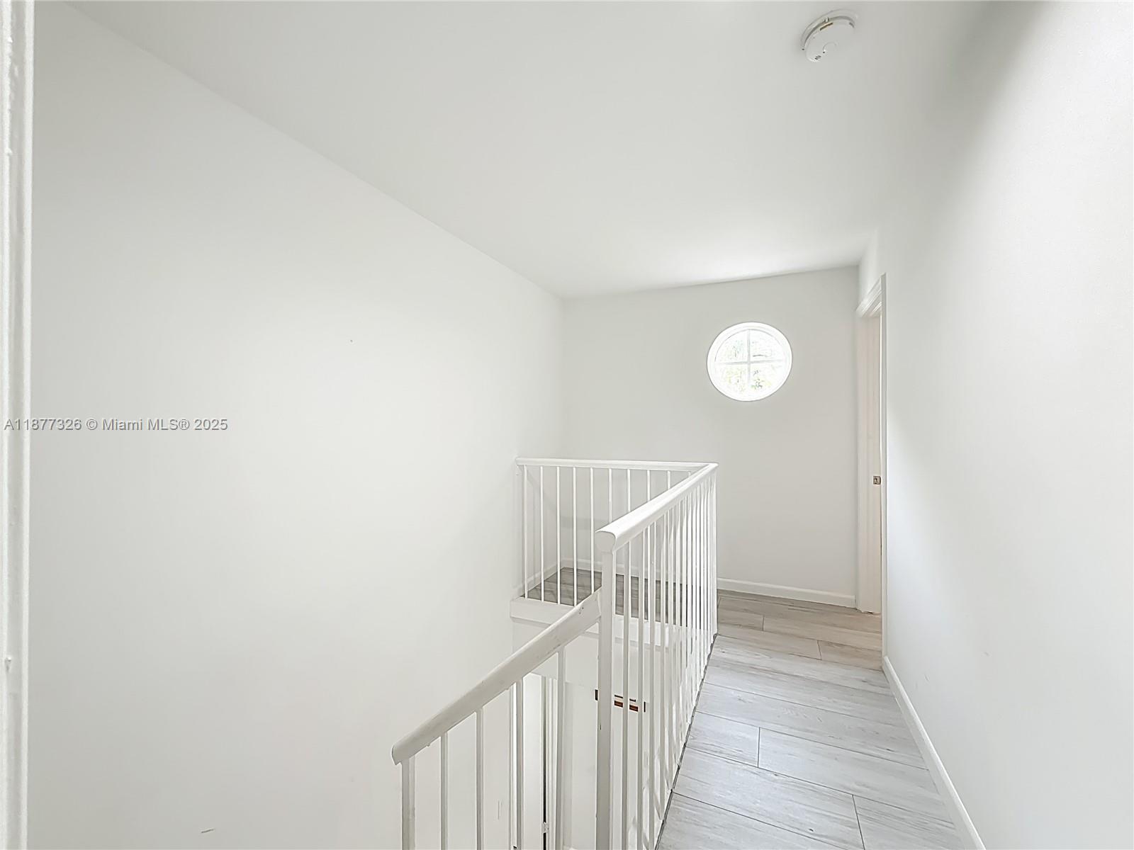 7110 Southwest 54th Street Miami, FL 33155 - Photo 22 of 40 a view of a hallway with wooden floor