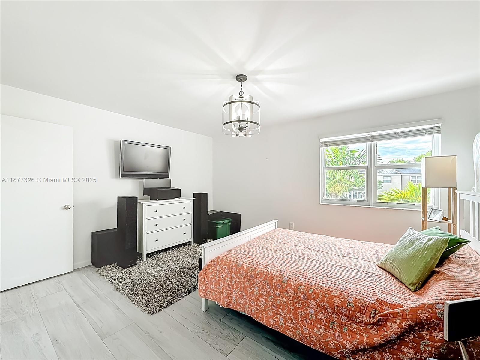 7110 Southwest 54th Street Miami, FL 33155 - Photo 24 of 40 a bedroom with a bed and a dresser