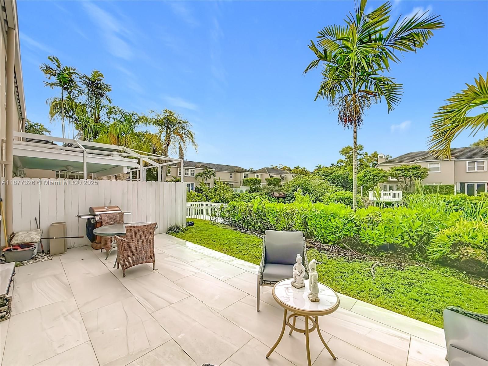 7110 Southwest 54th Street Miami, FL 33155 - Photo 29 of 40 a view of a chairs and table in patio with a lake view