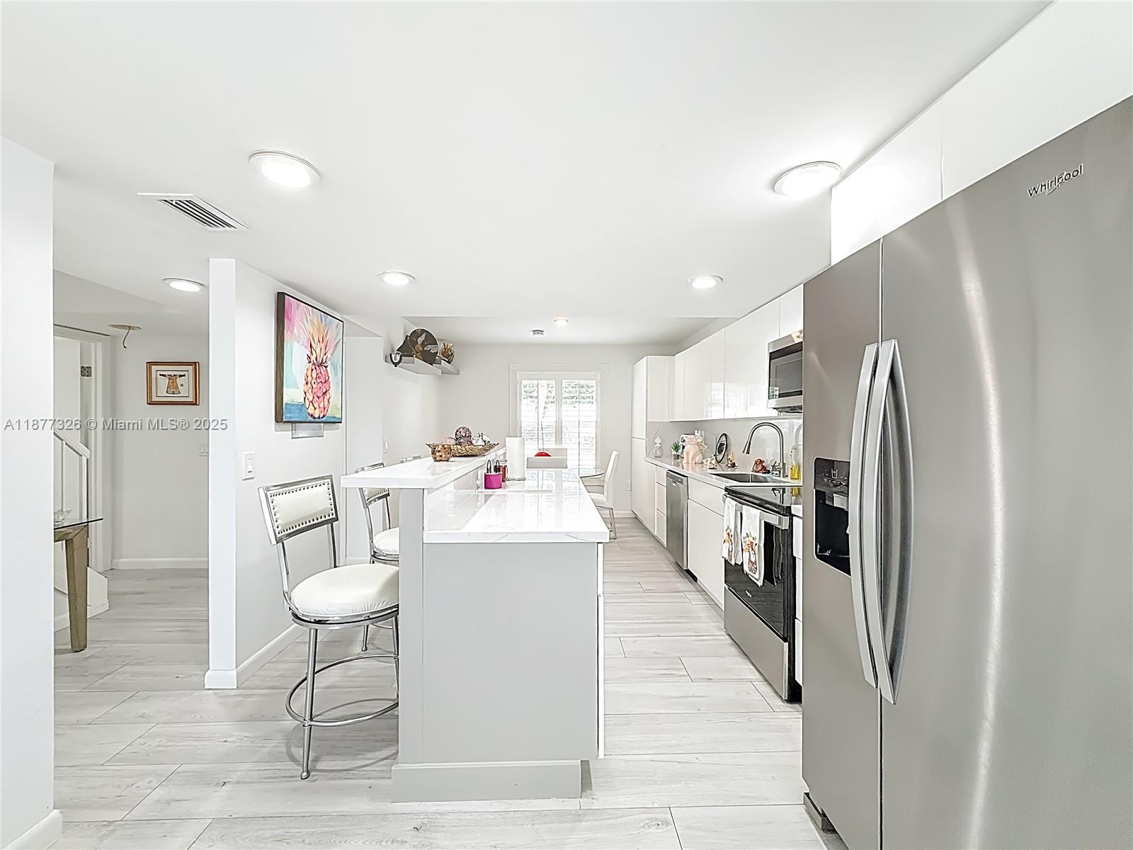 7110 Southwest 54th Street Miami, FL 33155 - Photo 3 of 40 a living room with stainless steel appliances furniture a refrigerator and kitchen view