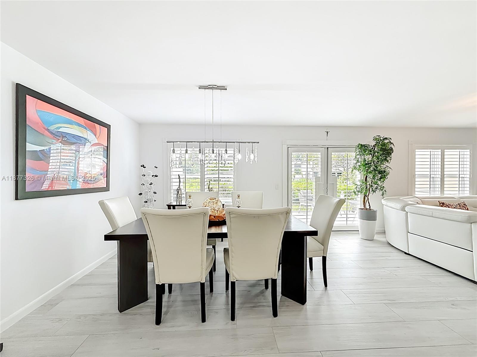 7110 Southwest 54th Street Miami, FL 33155 - Photo 5 of 40 a view of a dining room with furniture window and wooden floor