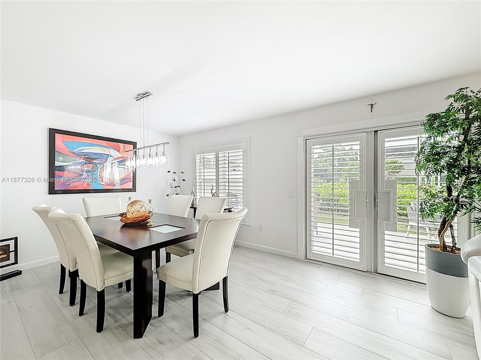 7110 Southwest 54th Street Miami, FL 33155 - Photo 6 of 40 a view of a dining room with furniture and wooden floor