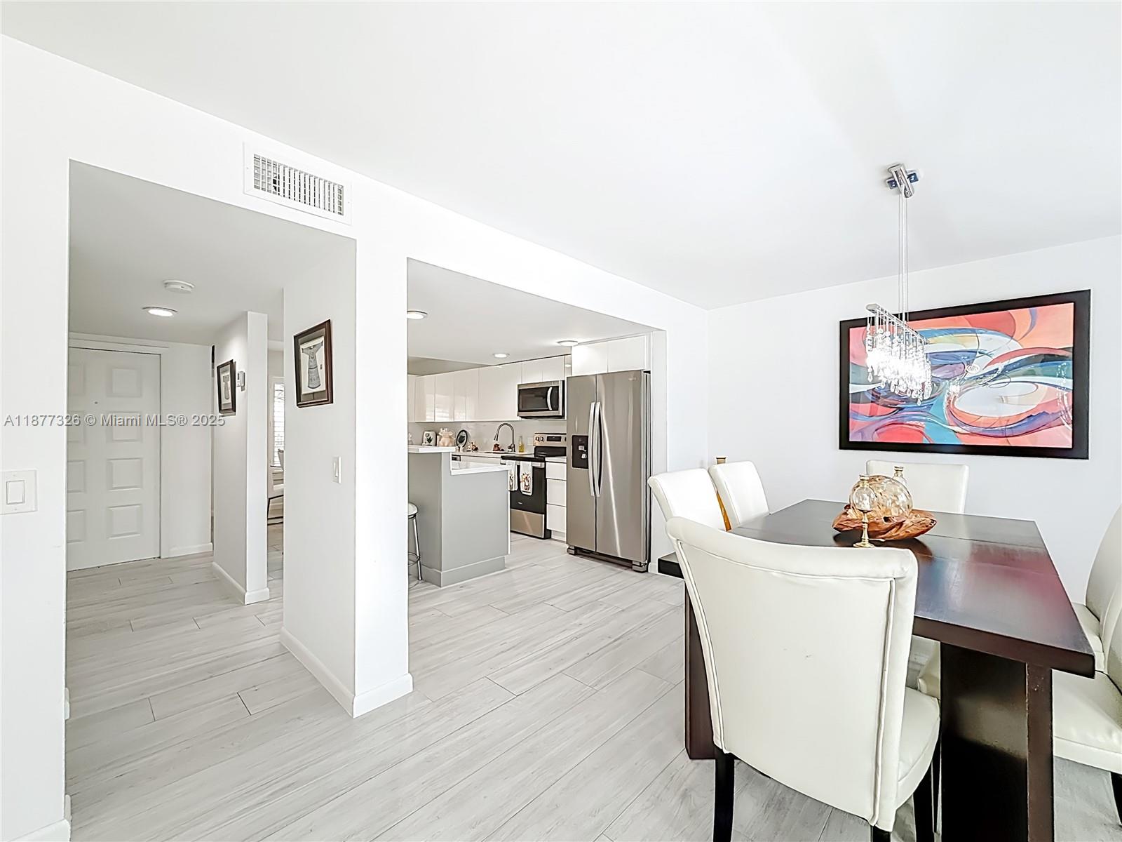7110 Southwest 54th Street Miami, FL 33155 - Photo 7 of 40 a view of a dining room with furniture and wooden floor