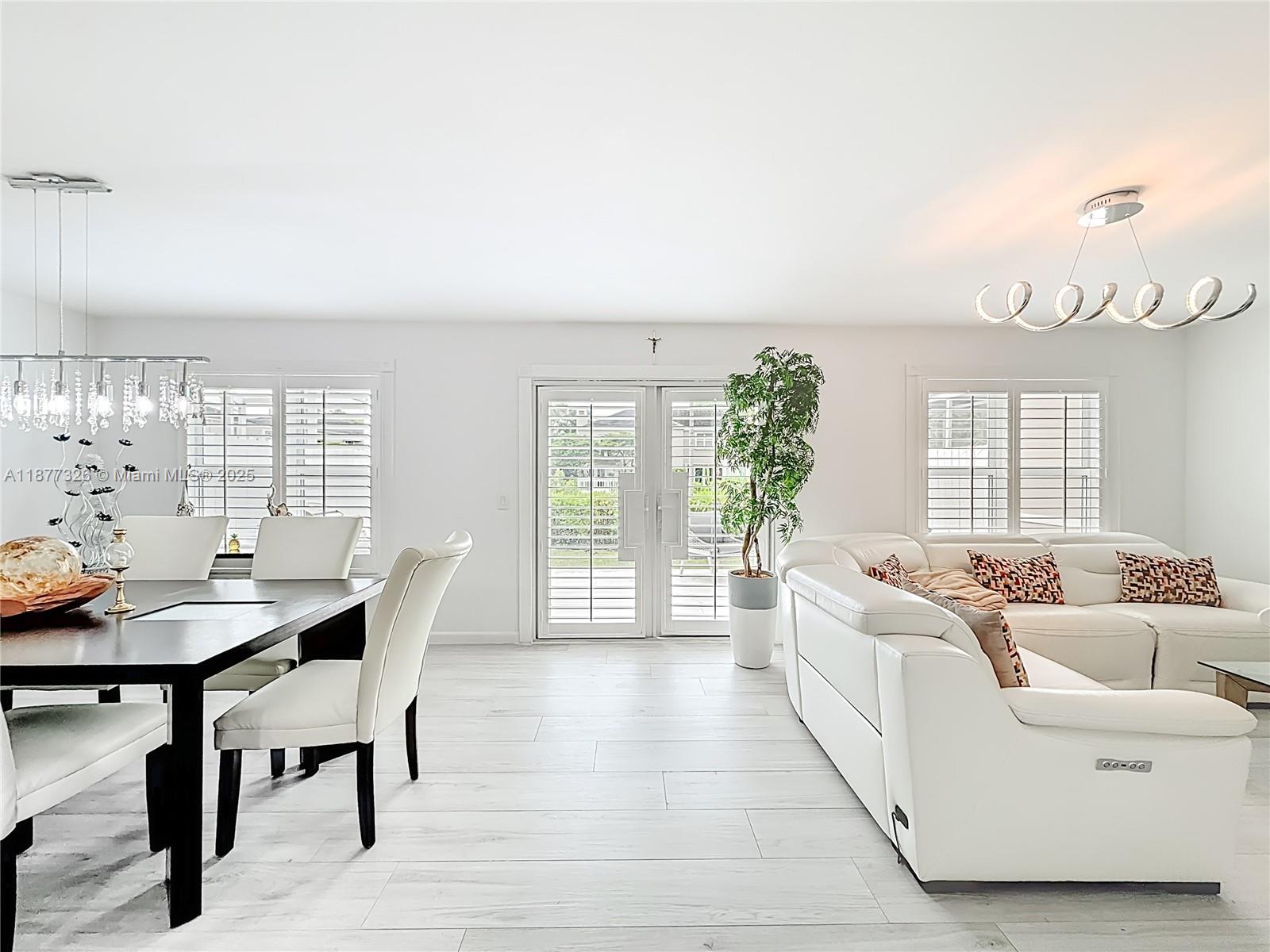 7110 Southwest 54th Street Miami, FL 33155 - Photo 8 of 40 a living room with furniture and wooden floor