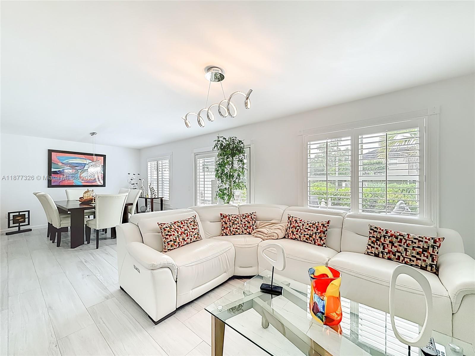 7110 Southwest 54th Street Miami, FL 33155 - Photo 10 of 40 a living room with furniture and a large window