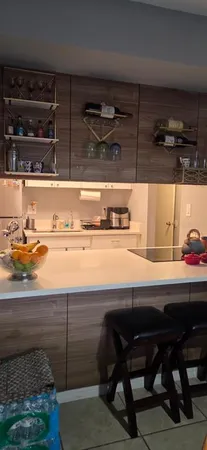 a room with a table chair and appliances