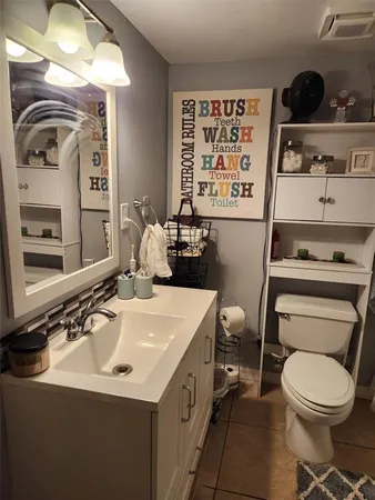 a bathroom with a sink a toilet and shower curtain
