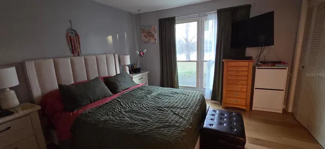 a bed sitting in a bedroom next to a window