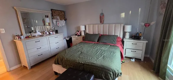 a bedroom with a bed and a mirror