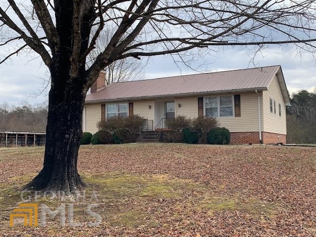 1102 Bill Presley Road Cleveland, GA 30528 - Photo 1 of 1 a front view of a house with a yard and garage