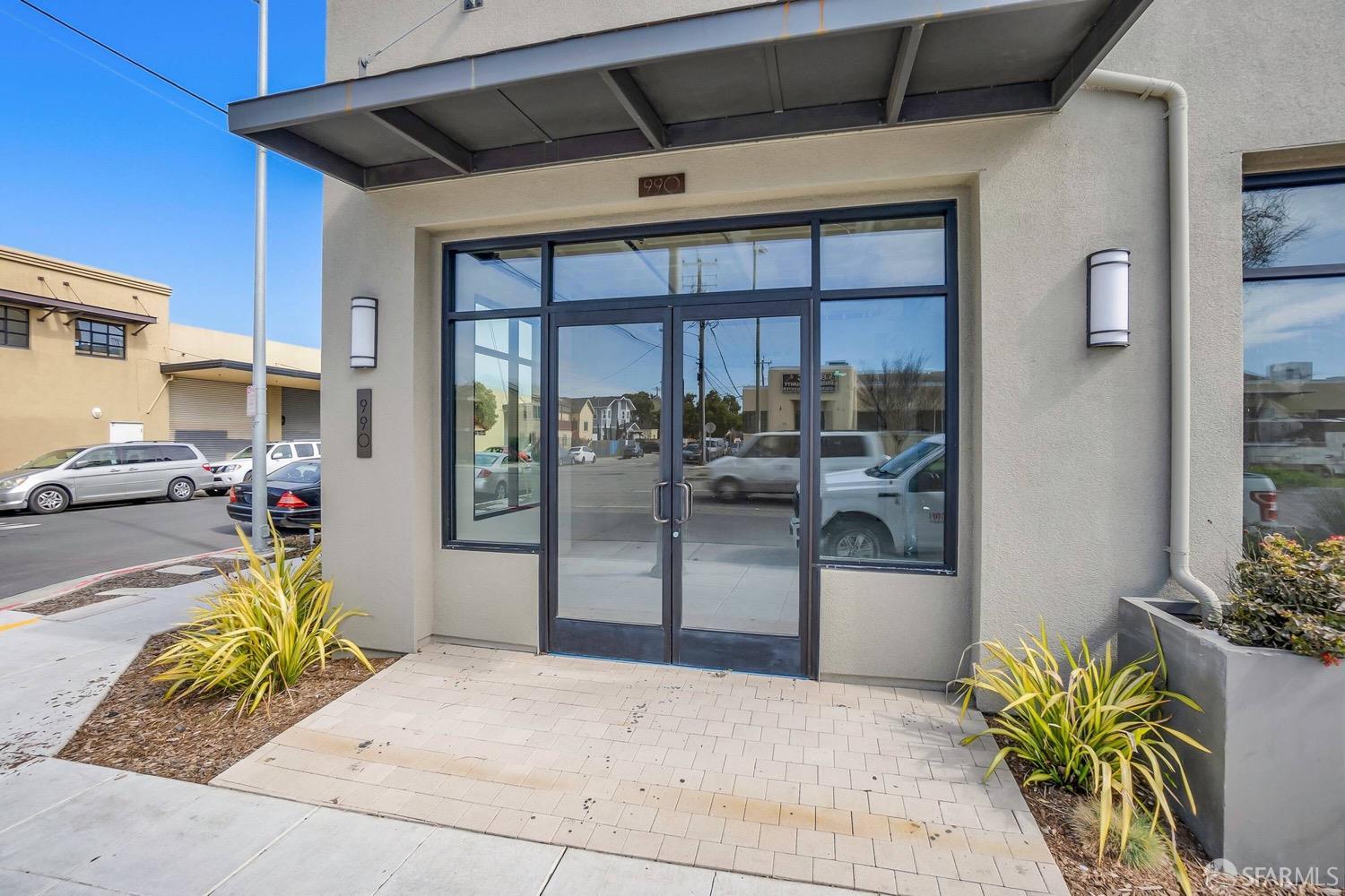 990 West Grand Avenue Oakland, CA 94607 - Photo 1 of 10 a view of a patio with a dining table and chairs under an umbrella
