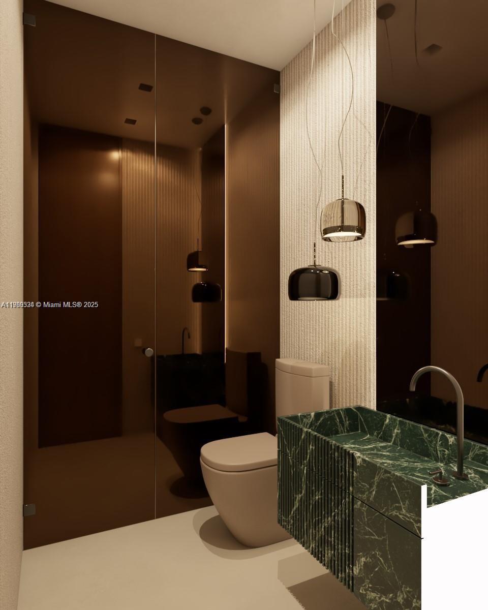 110 Hampton Lane Key Biscayne, FL 33149 - Photo 19 of 23 a bathroom with a sink and a mirror