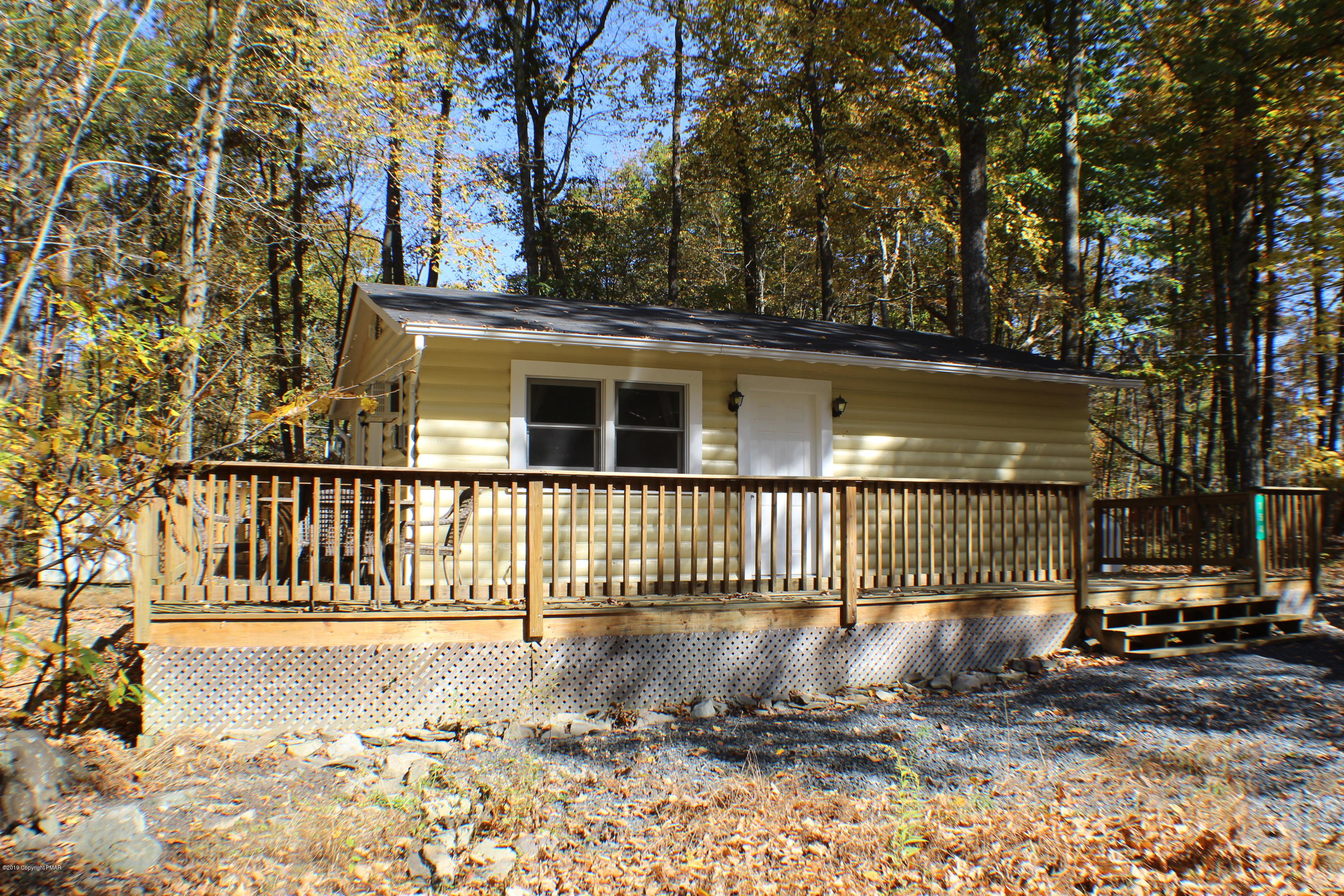 a view of a house with a wooden fence