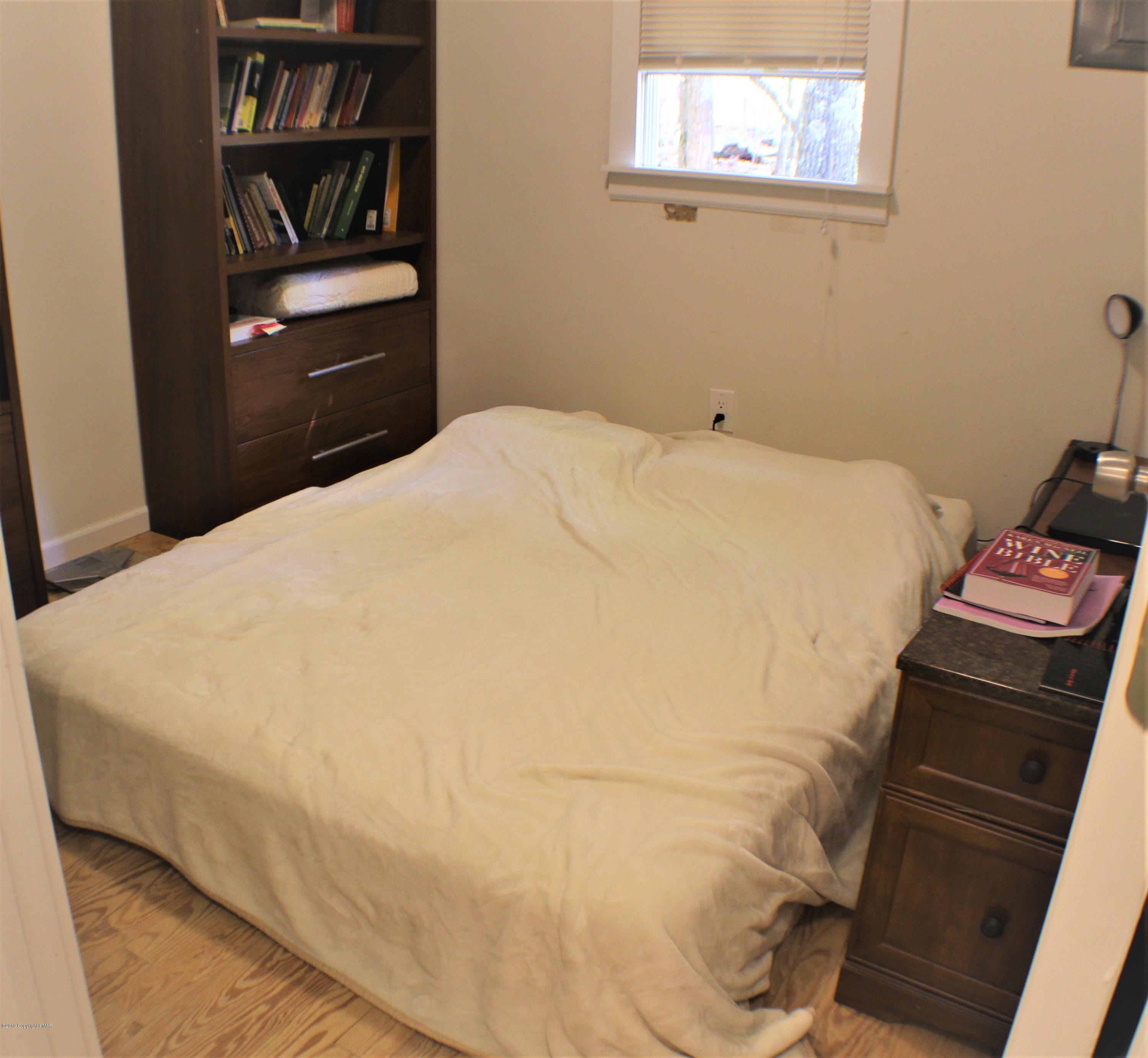154 Morris Road East Stroudsburg, PA 18302 - Photo 13 of 17 a large bed sitting in a bedroom next to a book shelf