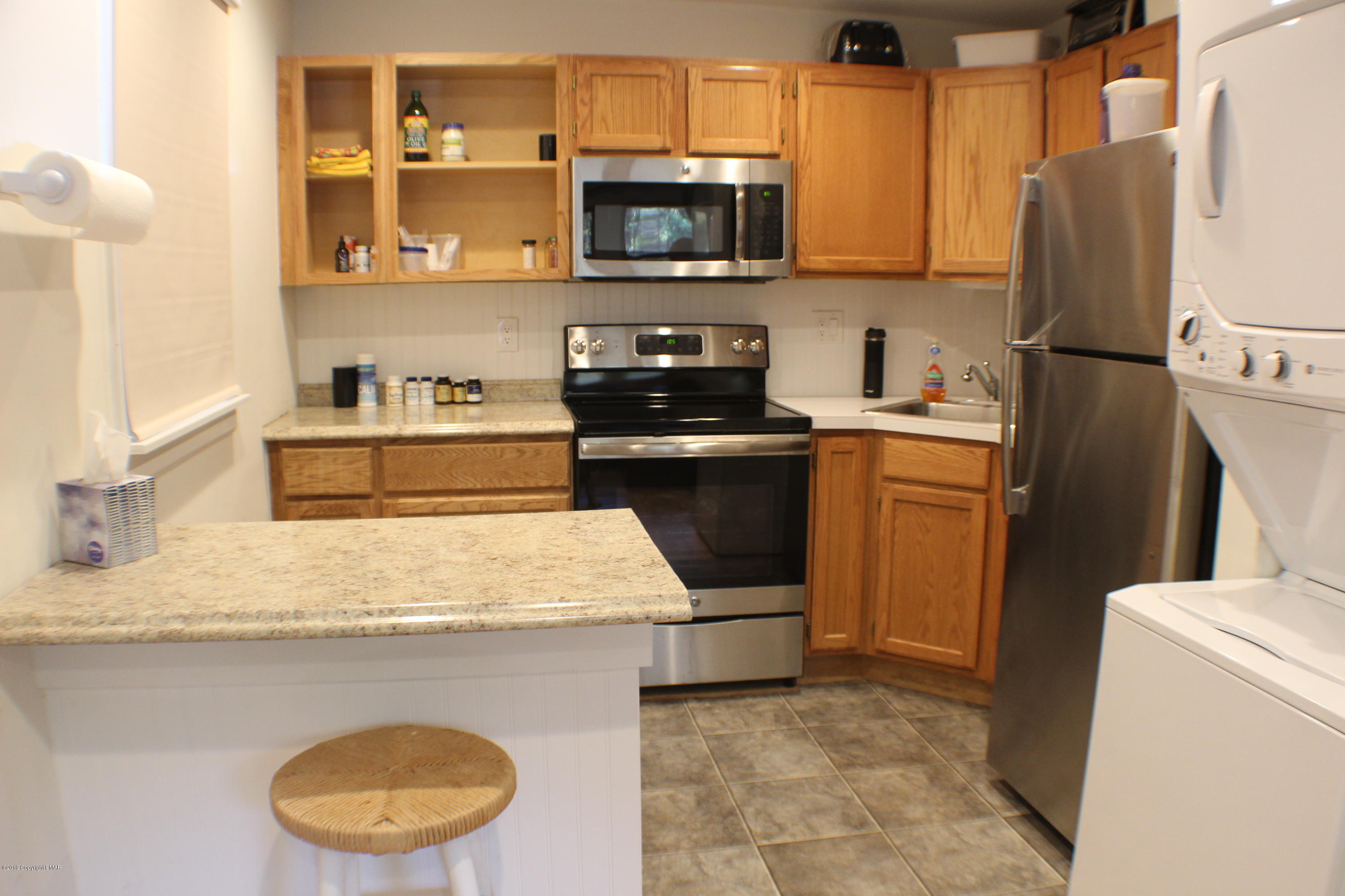 154 Morris Road East Stroudsburg, PA 18302 - Photo 9 of 17 a kitchen with stainless steel appliances granite countertop a sink stove and refrigerator