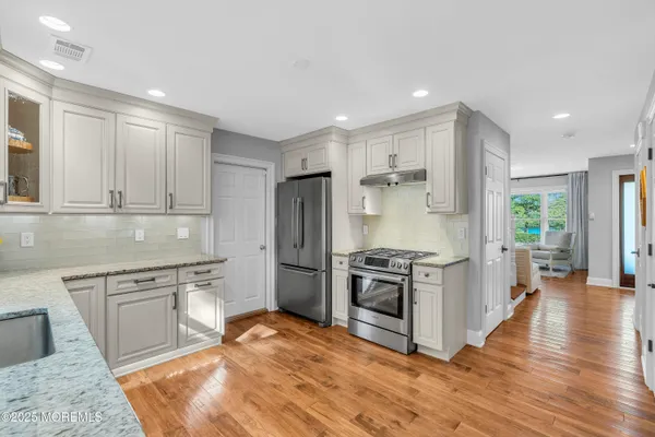 a kitchen with a stove a sink and a refrigerator