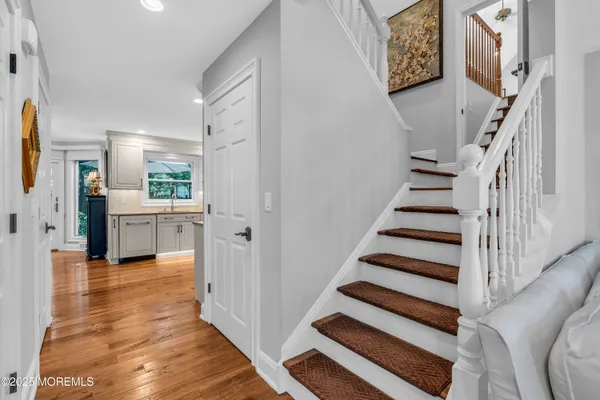 a view of a hallway with wooden floor and entryway