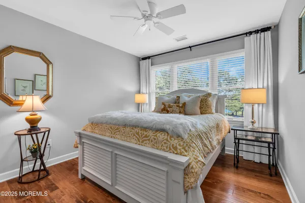 a bedroom with a bed a lamp and window