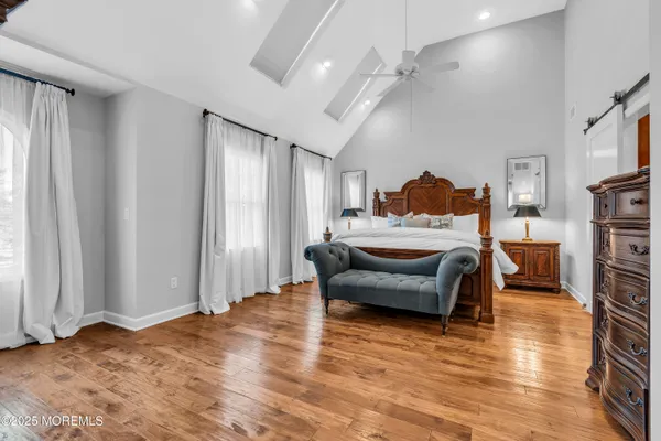 a bedroom with furniture window and wooden floor