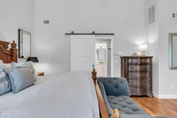 a bedroom with furniture and wooden floor