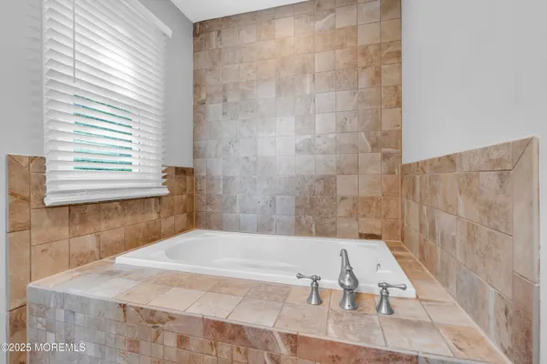 a bathroom with a bathtub and shower