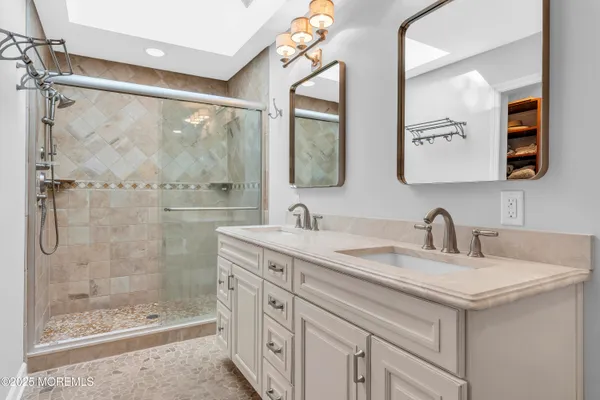 a bathroom with a granite countertop sink mirror and double