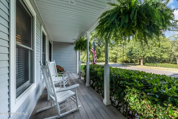 a view of balcony with furniture and garden