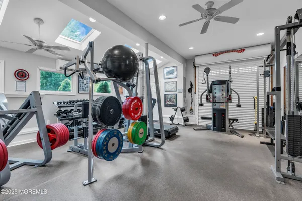 a room with gym equipment and mirror