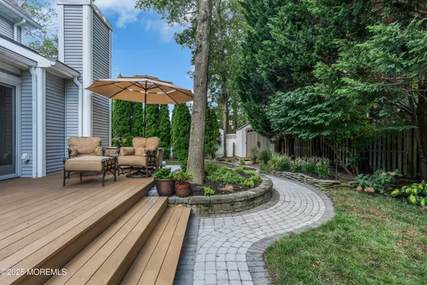 a view of a backyard with furniture and a garden