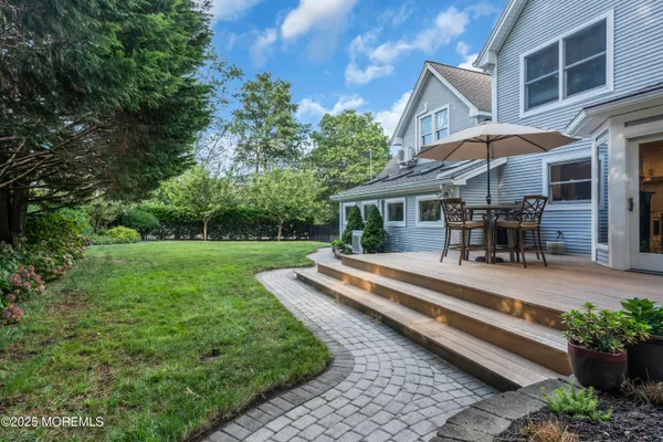 a view of a house with backyard porch and sitting area