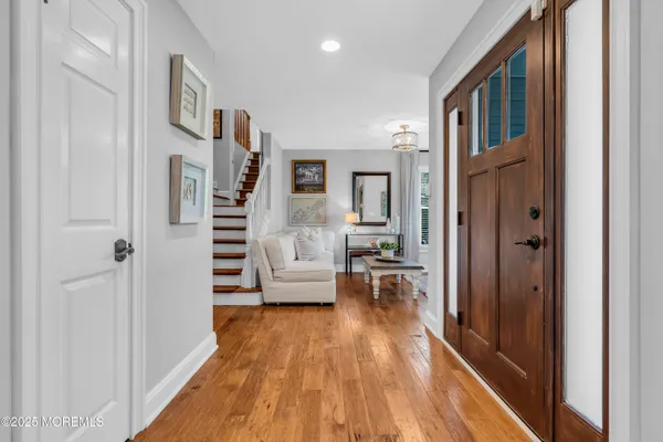a view of living room with furniture and wooden floor