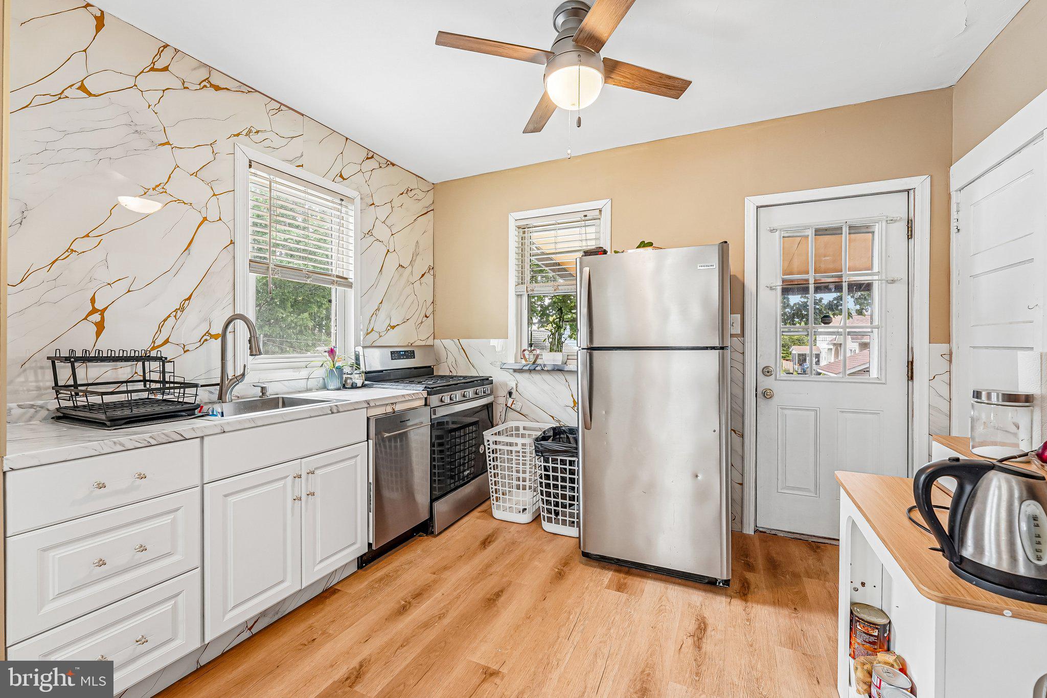 2267 Cove Road Pennsauken, NJ 08110 - Photo 3 of 34 a kitchen with a refrigerator a sink and dishwasher a oven with wooden floor