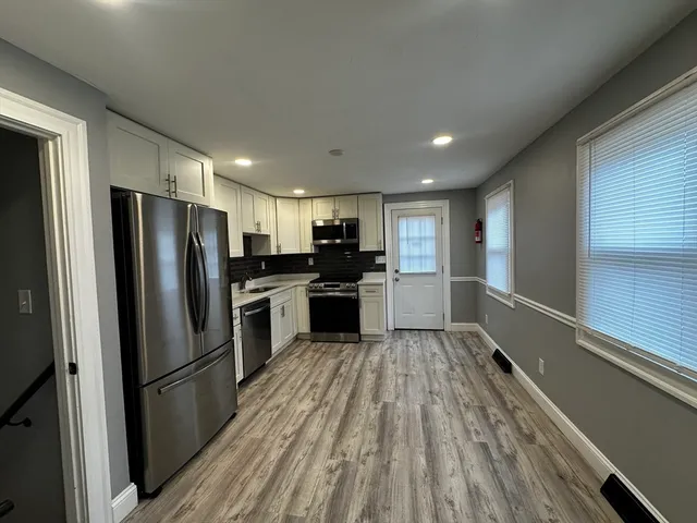 a kitchen with a refrigerator and a sink