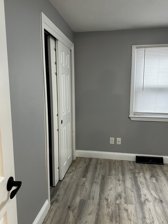 215 Belmont Avenue, Unit 1 Brockton, MA 02301 - Photo 19 of 30 a view of a room with wooden floor and a window