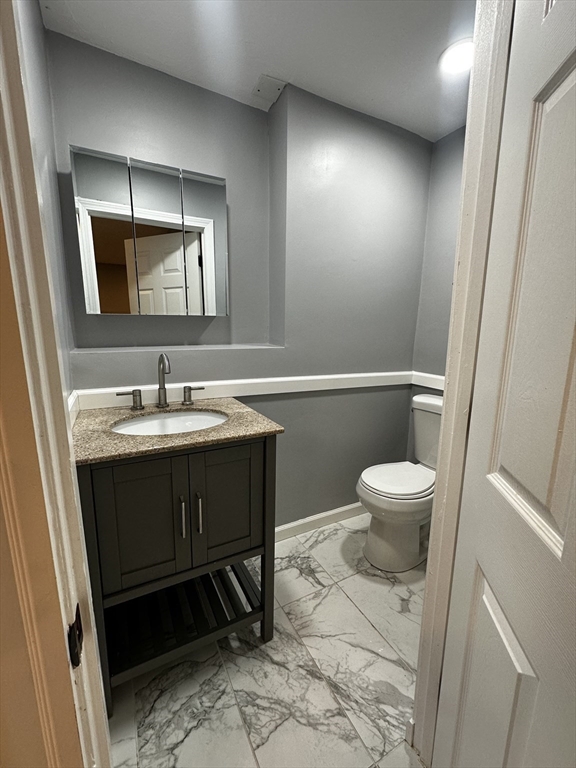 215 Belmont Avenue, Unit 1 Brockton, MA 02301 - Photo 25 of 30 a bathroom with a sink toilet and mirror
