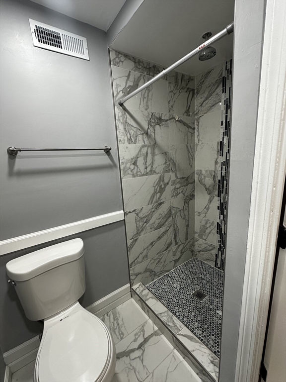 215 Belmont Avenue, Unit 1 Brockton, MA 02301 - Photo 26 of 30 a white toilet sitting next to a shower
