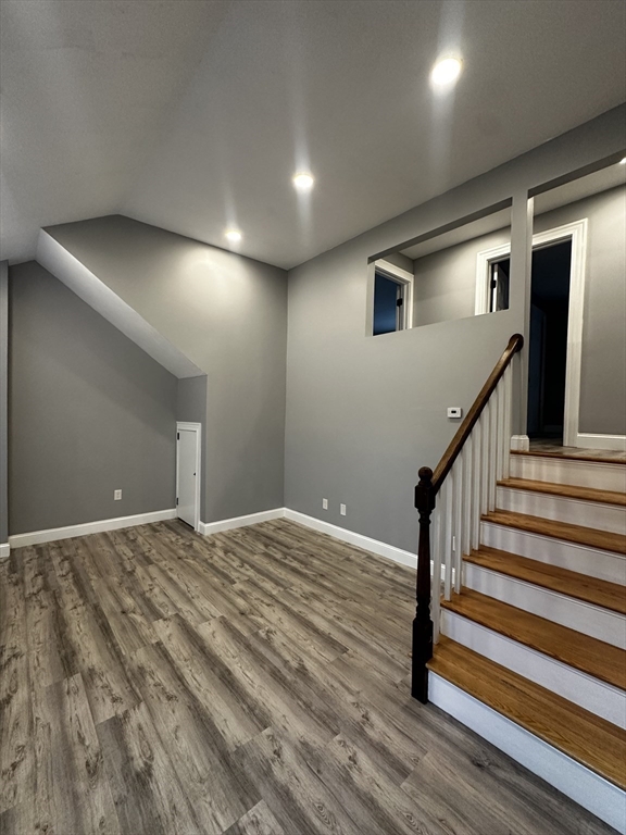215 Belmont Avenue, Unit 1 Brockton, MA 02301 - Photo 8 of 30 a view of a hallway with wooden floor and stairs