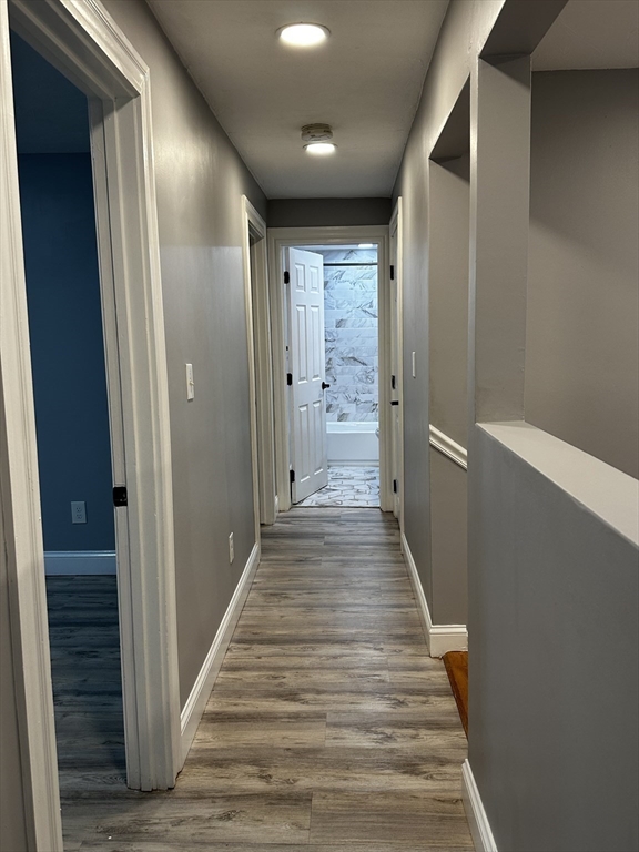 215 Belmont Avenue, Unit 1 Brockton, MA 02301 - Photo 10 of 30 a view of a hallway with wooden floor and staircase