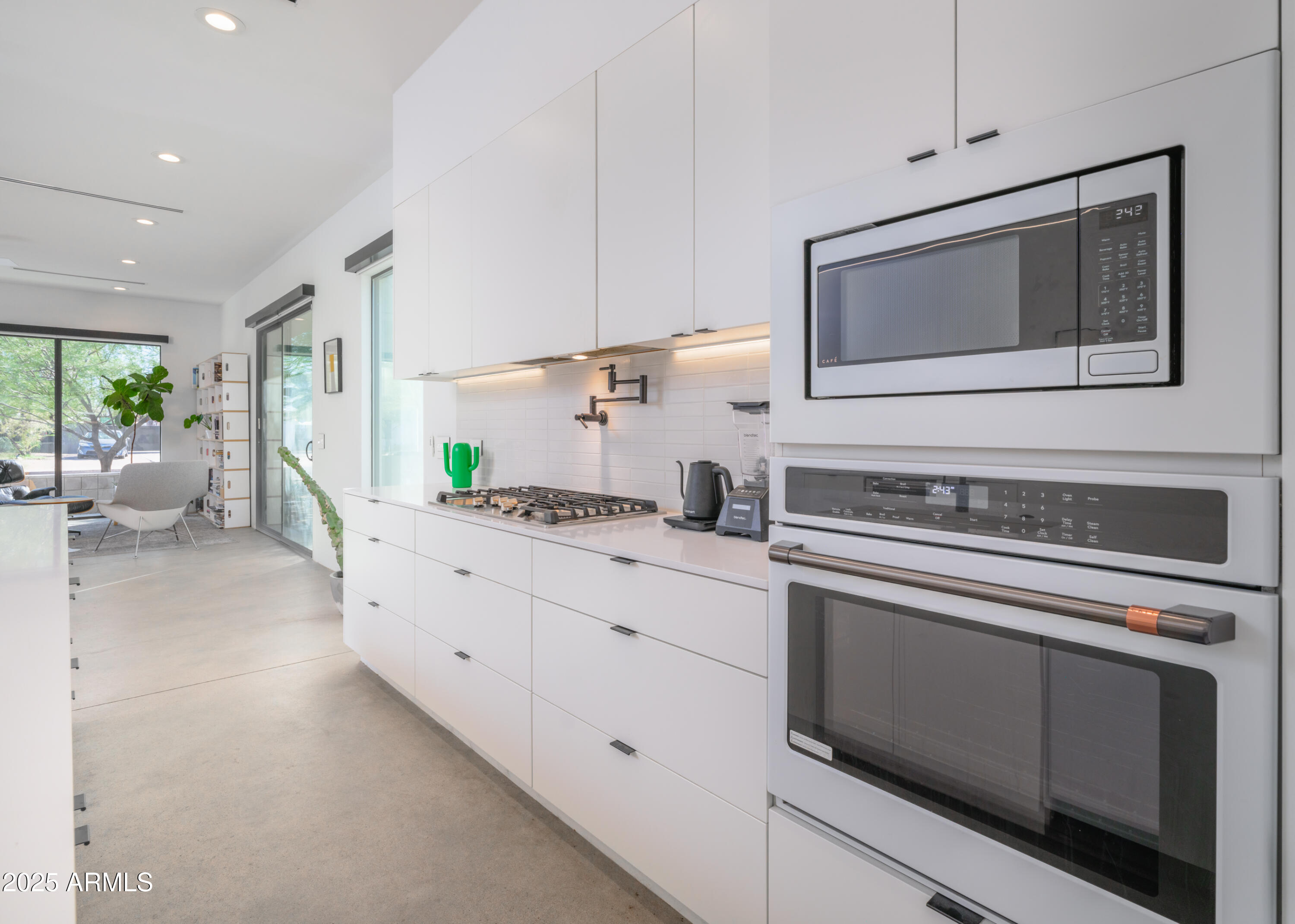 1526 East Coronado Road Phoenix, AZ 85006 - Photo 10 of 39 a kitchen with granite countertop white cabinets and white appliances