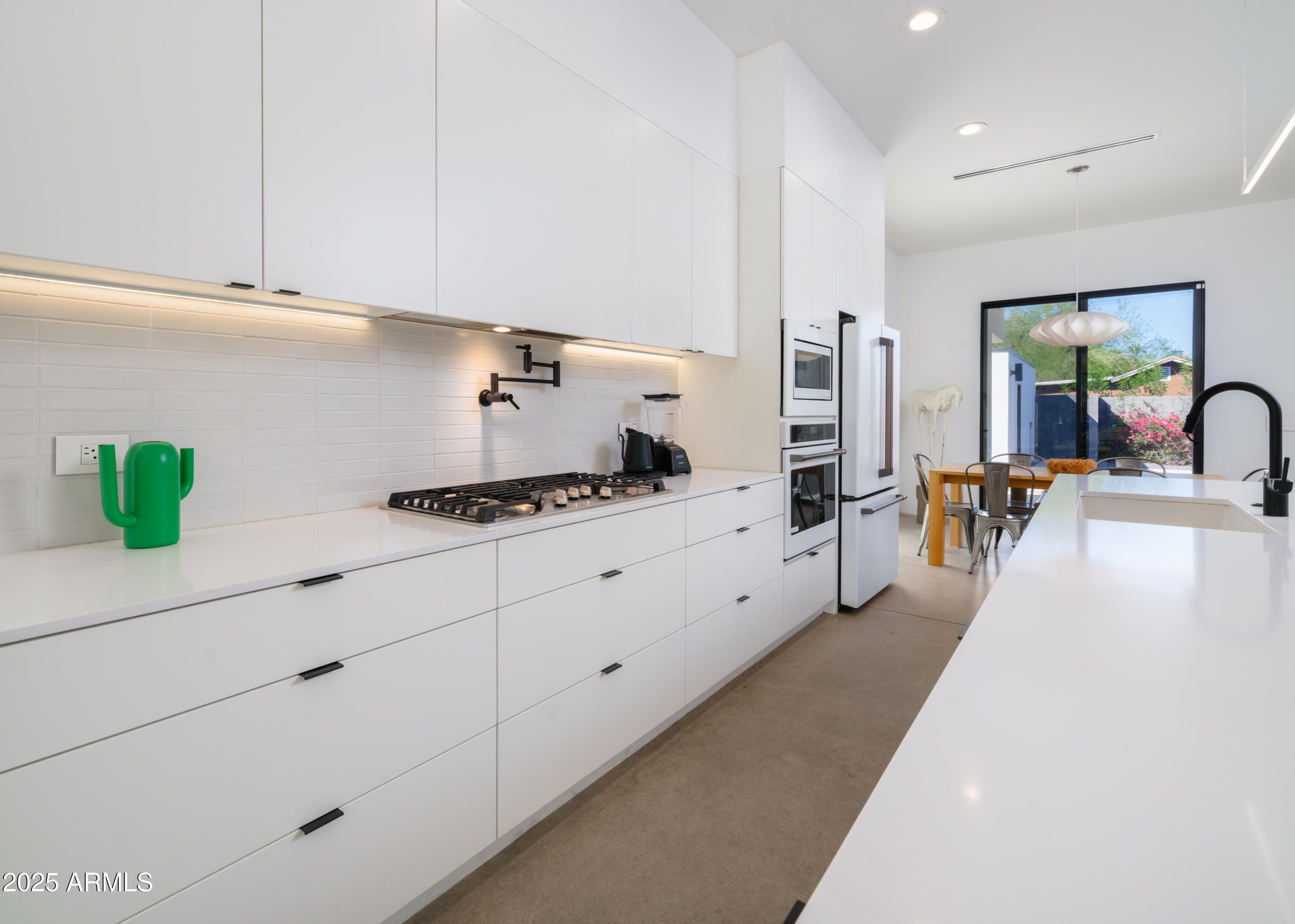 1526 East Coronado Road Phoenix, AZ 85006 - Photo 9 of 39 a large white kitchen with cabinets