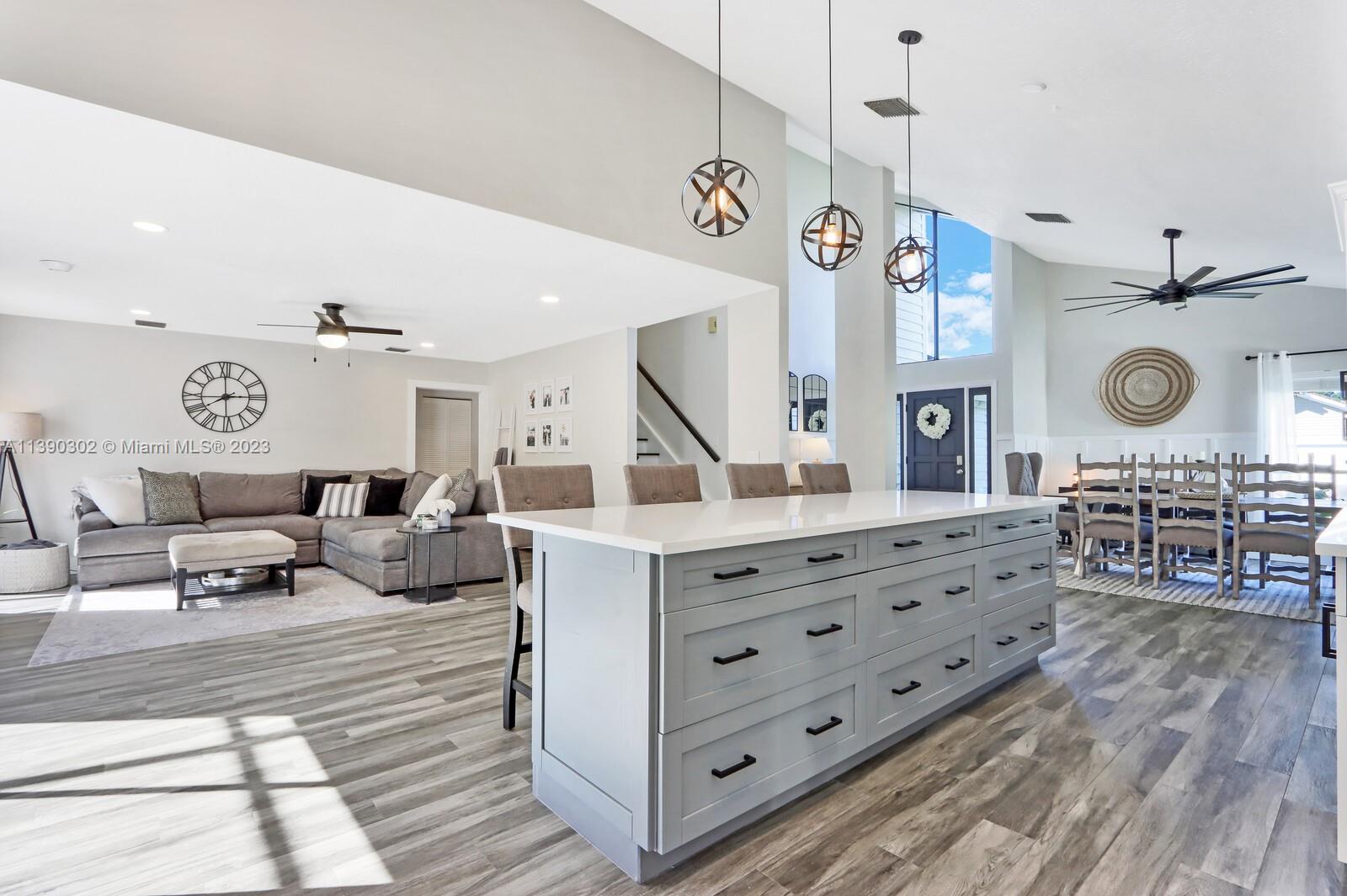 6122 Adams Street Jupiter, FL 33458 - Photo 13 of 59 a living room with furniture and a wooden floor