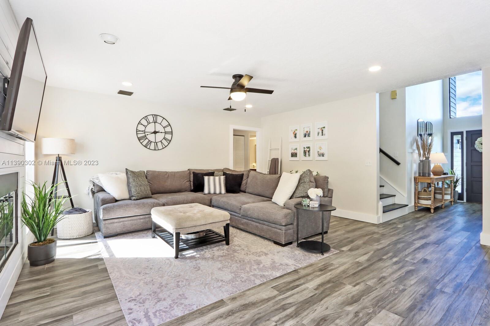 6122 Adams Street Jupiter, FL 33458 - Photo 16 of 59 a living room with furniture and wooden floor