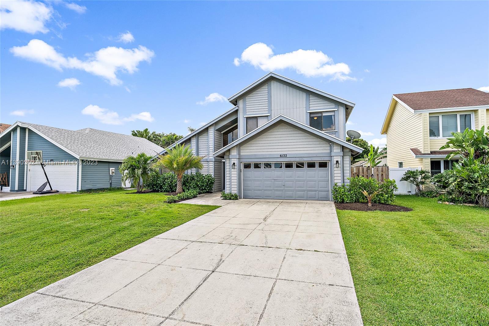 6122 Adams Street Jupiter, FL 33458 - Photo 2 of 59 a view of a house with a yard